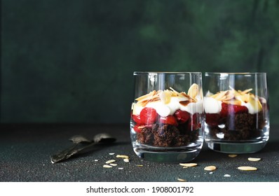 Dessert Black Forest With Cherries In A Glass On A Dark Green Background. Traditional German Dessert. Horizontal Focus.