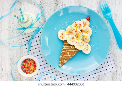 Dessert Or Breakfast For Kids - Pancake With Banana And Colorful Sugar Sprinkling In The Shape Of Ice Cream Cone. Creative Food Art Idea For Children Meal Top View