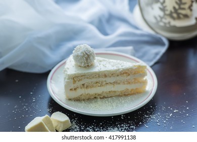 dessert cake with coconut candy balls on the window sill, decorative lamp, soft tissue - Shutterstock ID 417991138