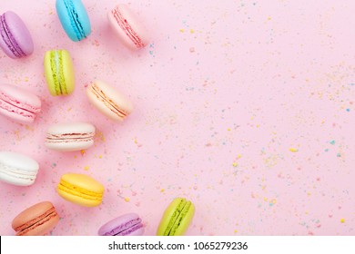 Dessert cake macaron or macaroon on pink background top view. Flat lay composition. - Powered by Shutterstock