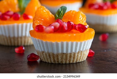 dessert. cake with tangerine slices and pomegranate seeds on a dark background - Powered by Shutterstock