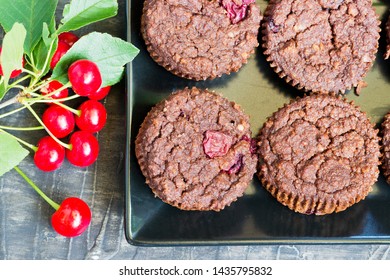 Dessert Chocolate Muffin With Sour Cherry Upon Dark Wooden Table, Top View