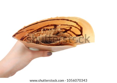 Dessert Chocolate Sauce with Dried Shredded Pork Crepes Pancake. Top view. Woman is Hand Manicure Holding Brown Crepe Homemade Isolated on White Background Great For Any Use.