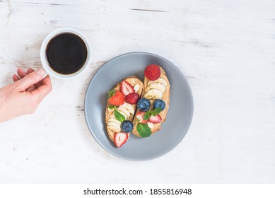 Dessert And A Cup Of Aromatic Coffee Is Held By A Woman's Hand Tomorrow With Peanut Butter Sandwiches.