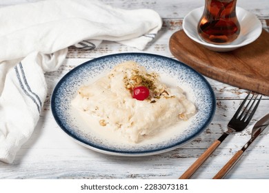 Güllaç dessert on wood background. Traditional Ramadan dessert. Güllaç dessert topped with sour cherry and pistachio - Shutterstock ID 2283073181