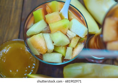 Dessert From Pieces Of Melon And Juice In A Glass Plate. On A Ba