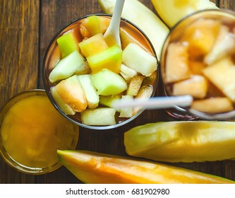 Dessert From Pieces Of Melon And Juice In A Glass Plate. On A Ba