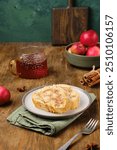 Dessert, sliced sponge roll with apple filling, on a rectangular plate on a brown wooden background. Apple recipes. Thanksgiving Day