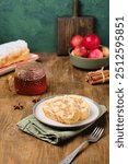 Dessert, sliced sponge roll with apple filling, on a rectangular plate on a brown wooden background. Apple recipes. Thanksgiving Day