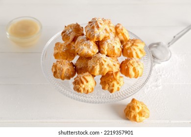 Dessert Stand With Delicious Eclairs On Light Table