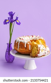 Dessert Stand With Pieces Of Tasty Easter Cake And Flower On Purple Background