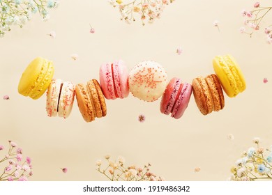 Dessert. Sweet colorful macarons or macaroons with flowers.