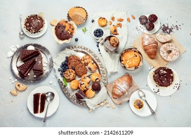 Dessert table with all kinds snacks on light background. Candy bar. Celebration concept. Top view, flat lay