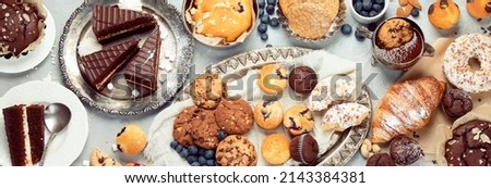 Dessert table with all kinds snacks on light background. Candy bar. Celebration concept. Top view, flat lay, panorama