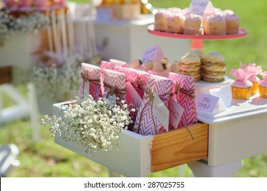 Dessert table with cakes decorated for a outdoor party