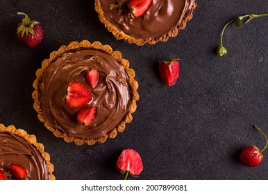 Dessert Tart Chocolate With Strawberries On A Black Background. View From Above. Copy Space