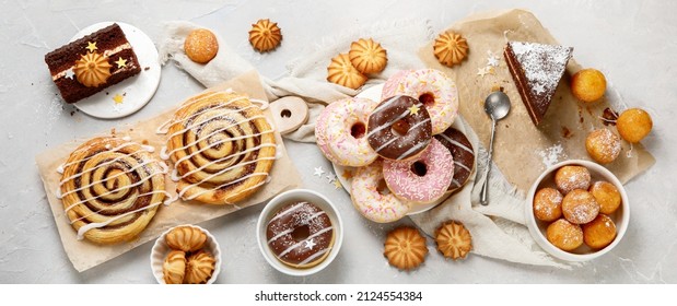 Desserts assortment on light background. Freshly made bakery and treats. Flat lay, top view, panorama