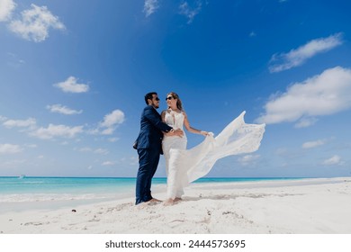 Destination wedding with a beautiful husband and wife couple in the beautiful waters of the Caribbean Sea - Powered by Shutterstock