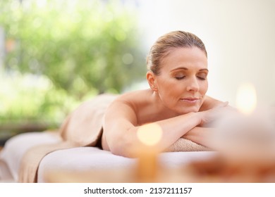 Destressing. Cropped Shot Of A Woman In A Day Spa Relaxing On A Massage Table.