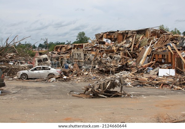 A\
destroyed apartment building  and vehicles in the aftermath of an\
EF 4 tornado that hit Tuscaloosa on April 27,\
2011.