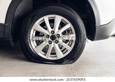 Destroyed blown out tire with exploded, shredded and damaged tire on a modern automobile. damaged truck rubber after tire explosion at high speed. Damaged flat tires: old car.