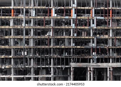 Destroyed facade of a multi-story office building as a result of a missile strike during the Russian-Ukrainian war. - Shutterstock ID 2174405953