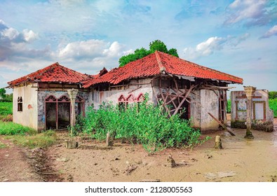 destroyed house on the eroded beach. - Shutterstock ID 2128005563