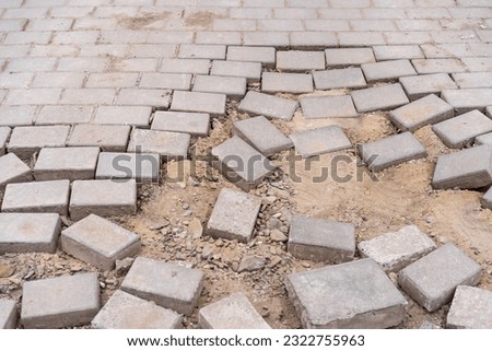 Destroyed pavement made of paving slabs unsuitable for people with limited mobility. Dangerous urban environment. Background with copy space for text