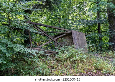 Destroyed raised hide for hunting in the middle of the forest