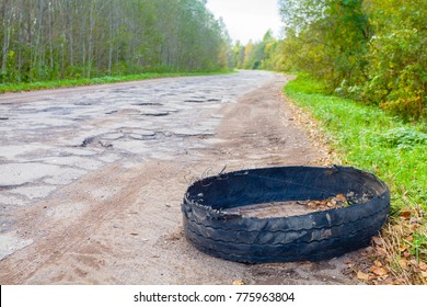 Destroyed Rubber Car Tire Car On Rural Bumpy Broken Road