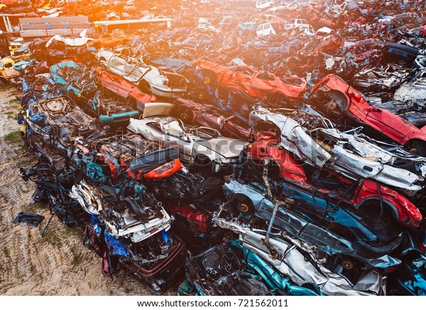 Destroyed scrapped cars stacked on a scrap\
yard. Car recycling