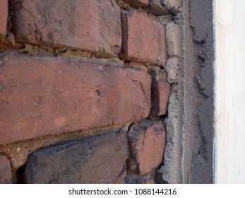 Destroyed surface. The old one. Bricks in the wall.
