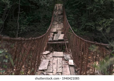 Destroyed Suspension Bridge Over A Mountain River (concept: Dangerous Path)