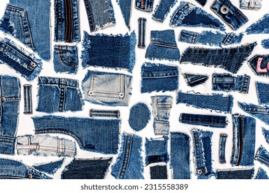 Destroyed torn denim blue jeans fabric pieces on white background, flat lay. Recycle old jeans denim concept. Love Denim Jeans.