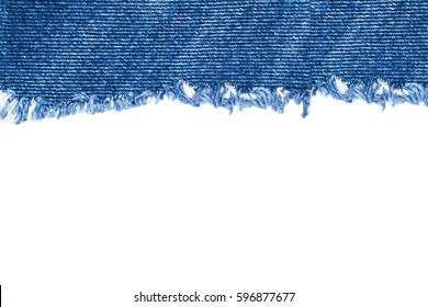 Destroyed torn denim blue jeans fabric frame on white background 