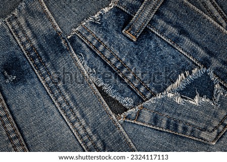 Destroyed torn denim blue jeans patches background. Denim blue jeans fabric frame. Ripped denim cloth. Recycle old jeans denim pieces concept. Many fragments of jeans cloth.