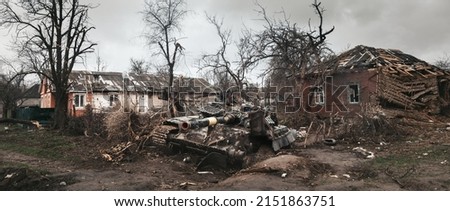 Destroyed Ukrainian tank surrounded by destroyed houses on the outskirts of Chernihiv