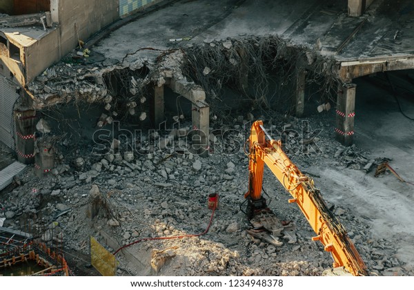 Destruction of\
the old road tunnel and the construction of a new junction.\
Excavator or crane at a construction\
site.