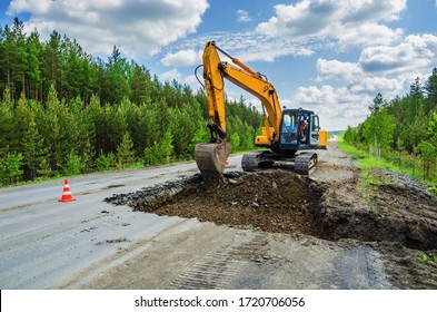 Destruction of the road surface on an intercity highway using an excavator to replace it