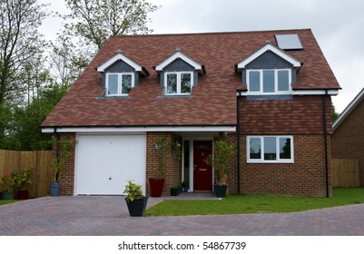 A Detached House With An Overcast Sky