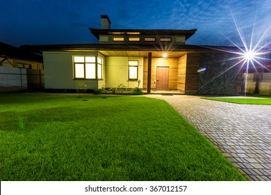 Detached Luxury House At Night View From Outside Front Entrance. 