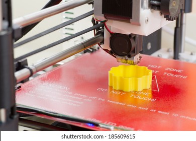 Detail Of A 3D Printer Printing With A Yellow ABS Filament