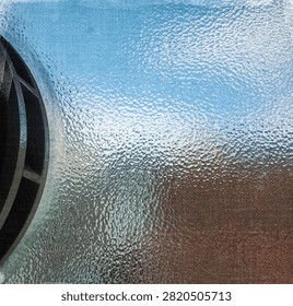 Detail of abstract patterns looking through old style textured glassused in walls of office partitions in an abandoned industrail factory building