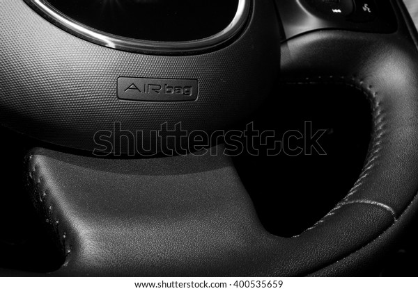 detail of the airbag device logo on leather\
steering wheel
