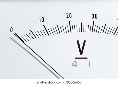Detail of an analog voltmeter, pointer and scale