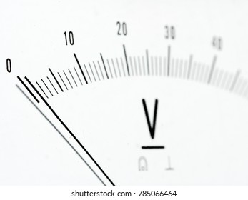 Detail of an analog voltmeter, pointer and scale
