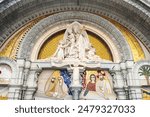 Detail of the architecture and exterior statue of the church at Lourdes in France