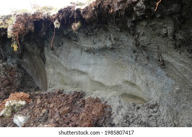 Detail of arctic permafrost thawing in Alaska and Canada, global warming climate change concept, collapse of soil mud and create thermokarst lake - Shutterstock ID 1985807417