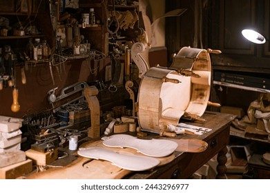 Detail of the artisan manufacture of a viola or cello by the master luthier in his old manual workshop - Powered by Shutterstock