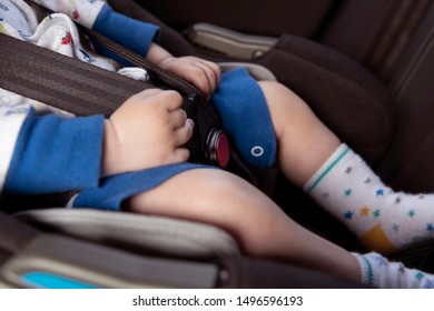 Detail Of The Baby In The Rear Facing Car Seat: Focus On The Buckle